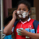 A young girl leaves school, which is out for the week as a result of the awful air pollution.